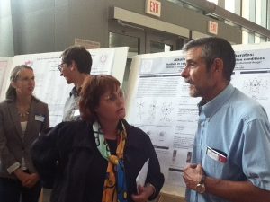 Two professors discussing a poster.