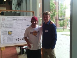 two students in front of a research poster.