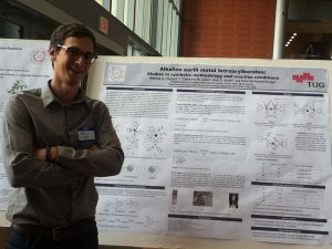 Student in front of his research poster