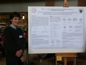 Student in front of his research poster.
