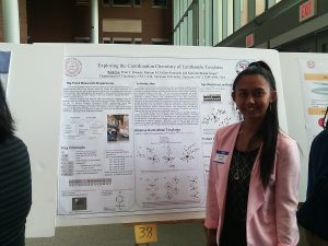 Student in front of her research poster.