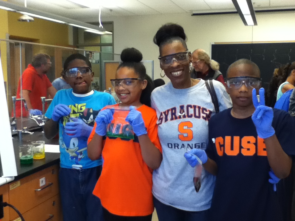 Four students holding bags of slime that they created in the lab.